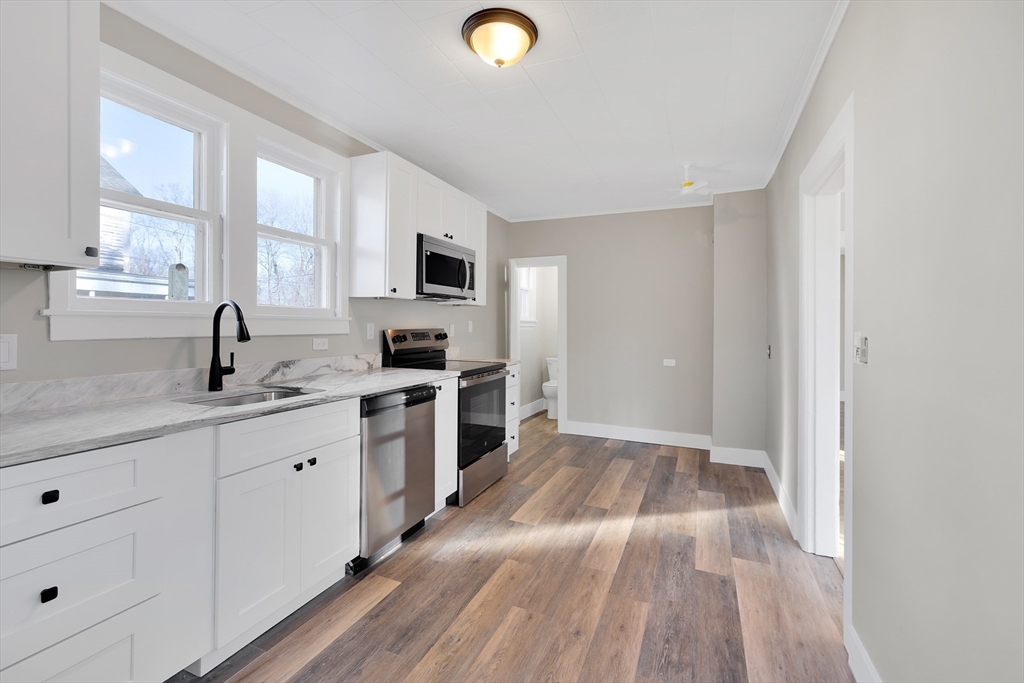 24 Flynt Avenue Monson, MA 01057 - Photo 16 of 29 a kitchen with granite countertop a sink cabinets and stainless steel appliances
