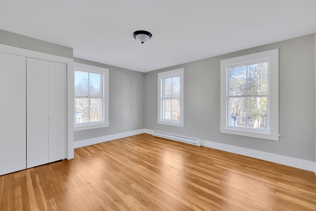 24 Flynt Avenue Monson, MA 01057 - Photo 20 of 29 a view of an empty room with wooden floor and a window