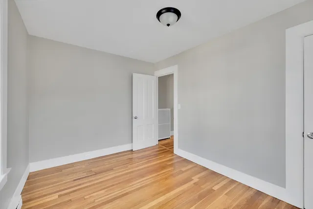a view of room with wooden floor