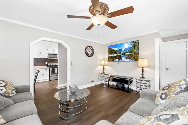a living room with furniture and a wooden floor