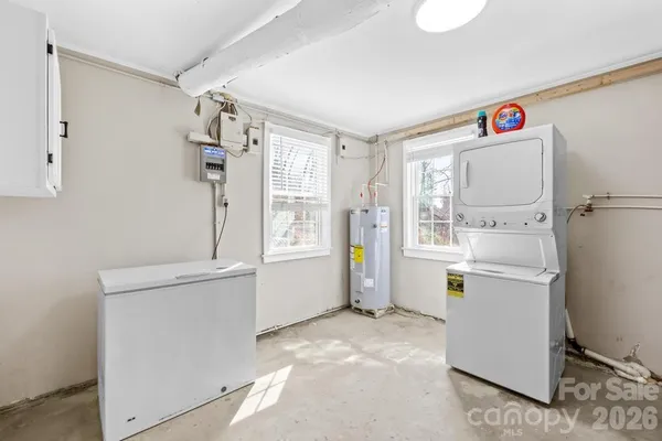 a utility room with cabinets washer and dryer