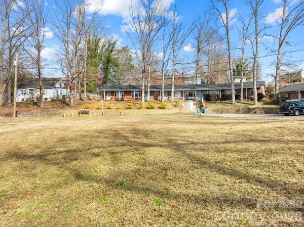 a swimming pool with outdoor seating and yard