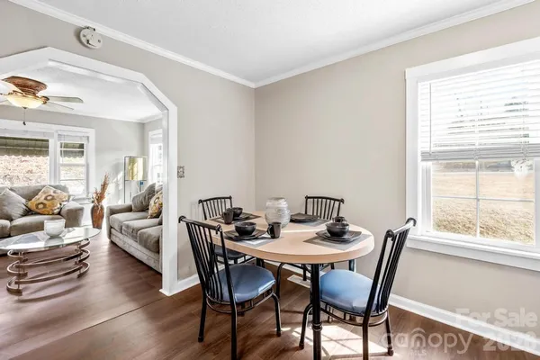 a view of a dining room with furniture and wooden floor
