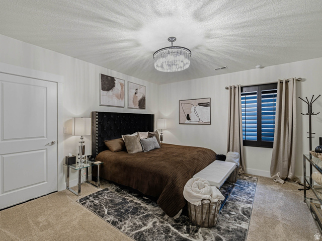 1154 Sunset Dunes Way Draper, UT 84020 - Photo 45 of 50 Carpeted bedroom featuring a textured ceiling and suspended lighting
