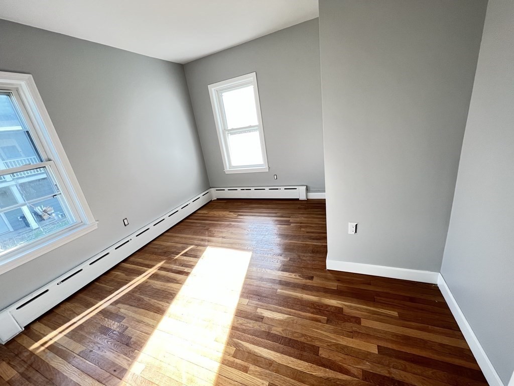 25 Teragram Street, Unit 1 Boston, MA 02128 - Photo 11 of 21 a view of a room with wooden floor and staircase