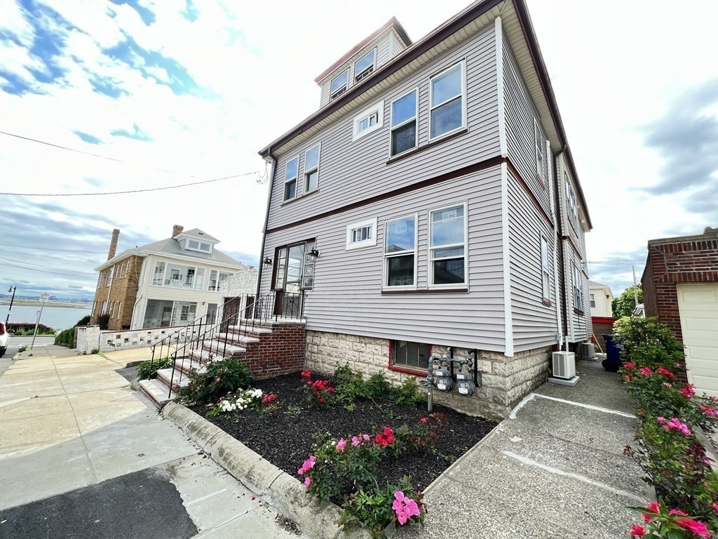 25 Teragram Street, Unit 1 Boston, MA 02128 - Photo 20 of 21 a front view of a house with a garden