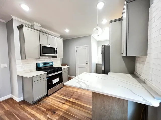 a kitchen with a stove a sink and a refrigerator
