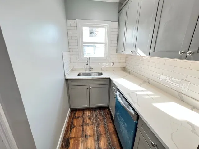a kitchen with a sink a window a washer and dryer