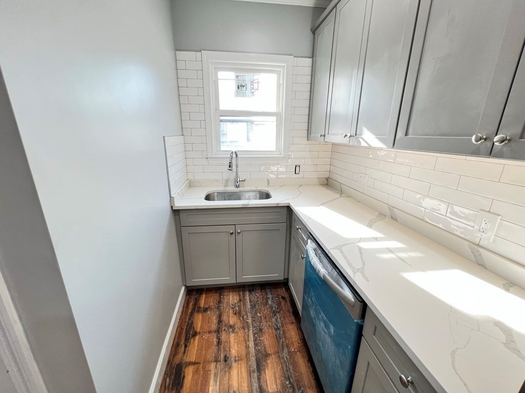 25 Teragram Street, Unit 1 Boston, MA 02128 - Photo 4 of 21 a kitchen with a sink a window a washer and dryer