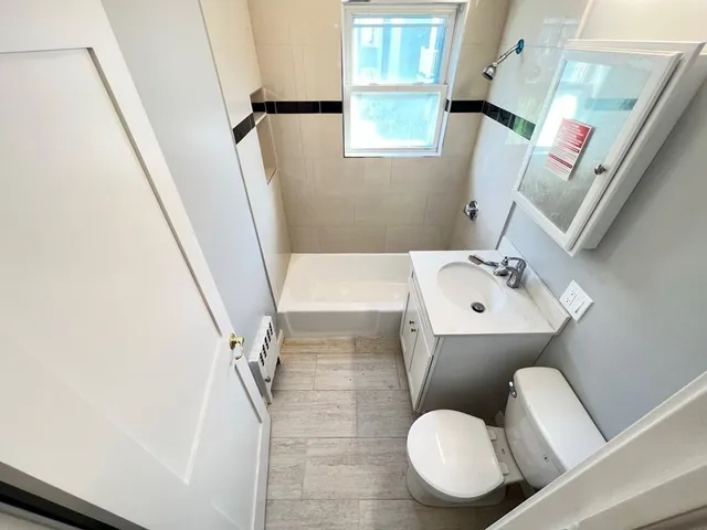 a bathroom with a sink toilet and mirror
