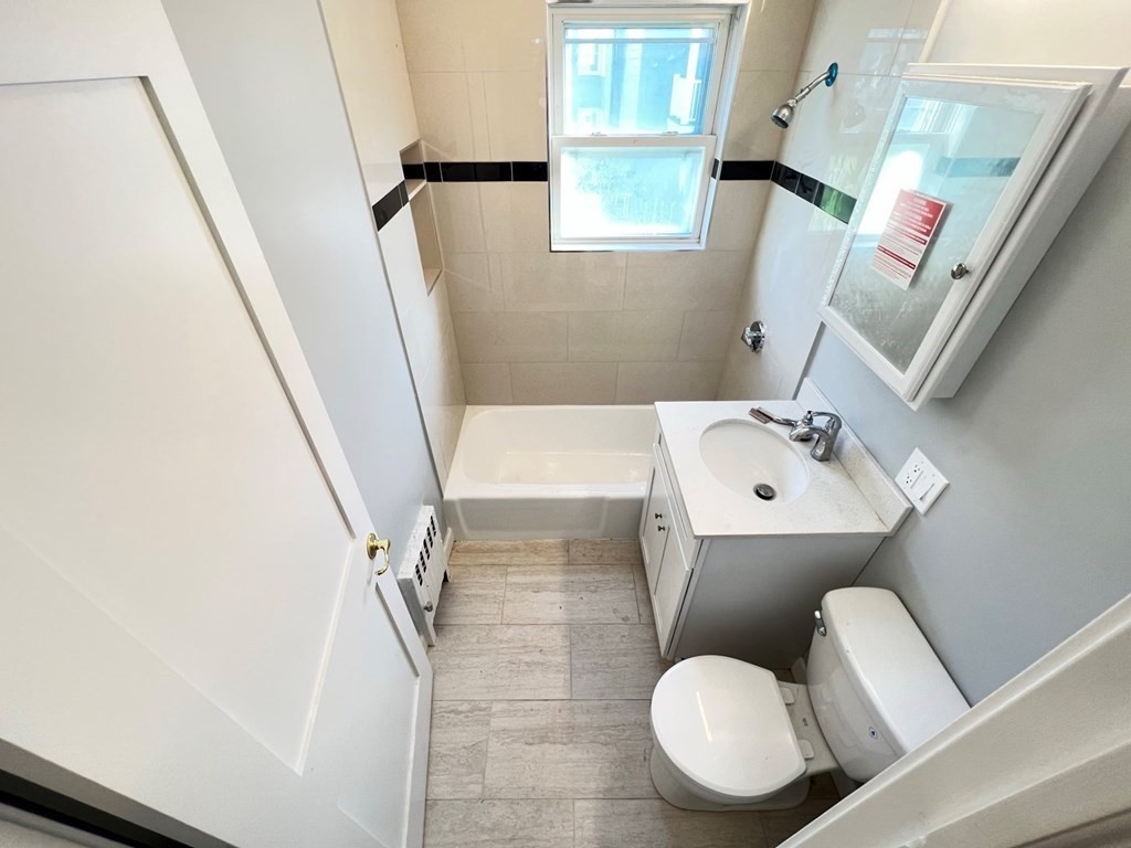 25 Teragram Street, Unit 1 Boston, MA 02128 - Photo 9 of 21 a bathroom with a sink toilet and mirror