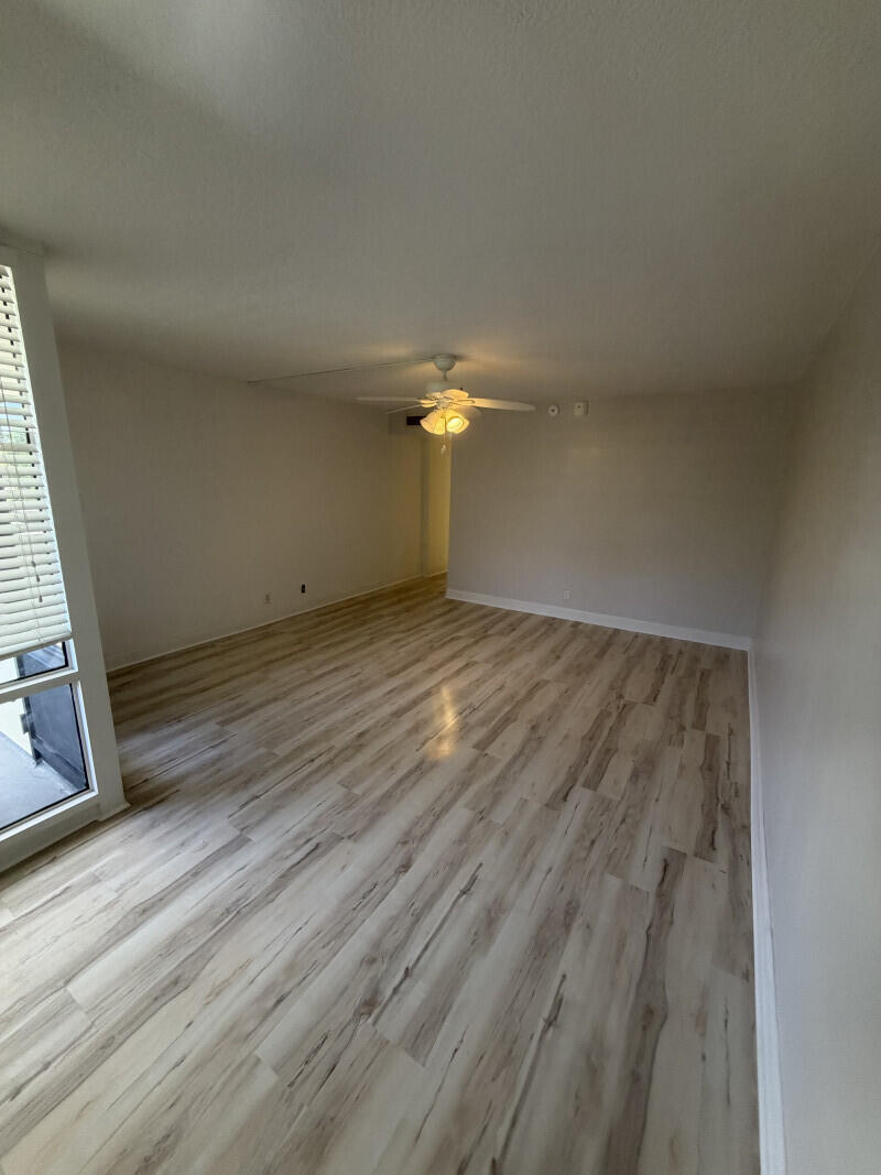 1401 South Federal Highway, Unit 102 Boca Raton, FL 33432 - Photo 12 of 38 an empty room with wooden floor fan and windows