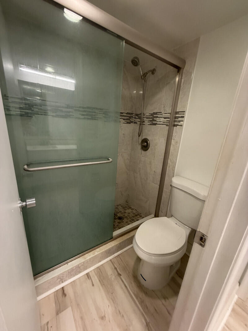 1401 South Federal Highway, Unit 102 Boca Raton, FL 33432 - Photo 15 of 38 a white toilet sitting next to a shower