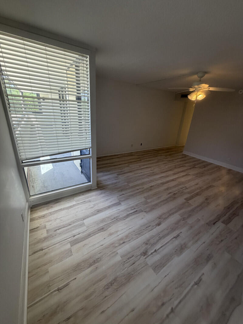 1401 South Federal Highway, Unit 102 Boca Raton, FL 33432 - Photo 16 of 38 a view of empty room with wooden floor and fan