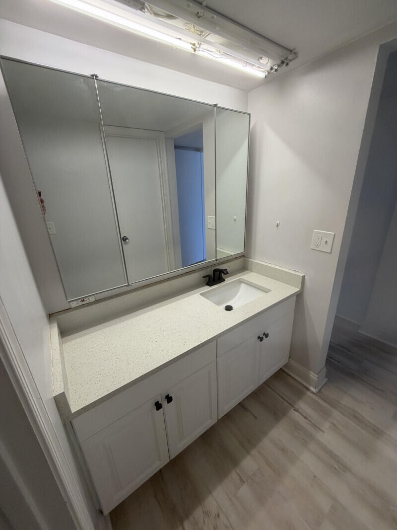 1401 South Federal Highway, Unit 102 Boca Raton, FL 33432 - Photo 17 of 38 a spacious bathroom with a double vanity sink and mirror