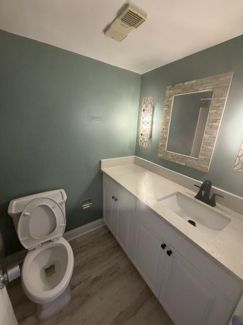 1401 South Federal Highway, Unit 102 Boca Raton, FL 33432 - Photo 19 of 38 a bathroom with a toilet sink and mirror
