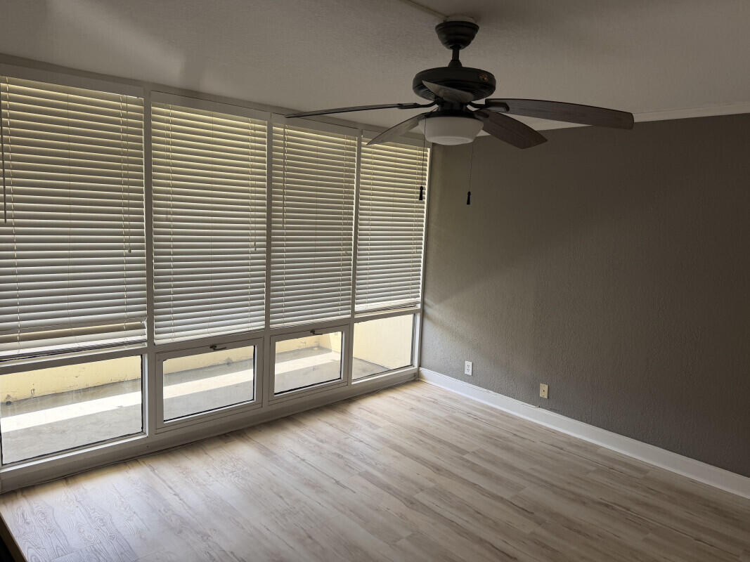 1401 South Federal Highway, Unit 102 Boca Raton, FL 33432 - Photo 24 of 38 a view of an empty room with a window and wooden floor