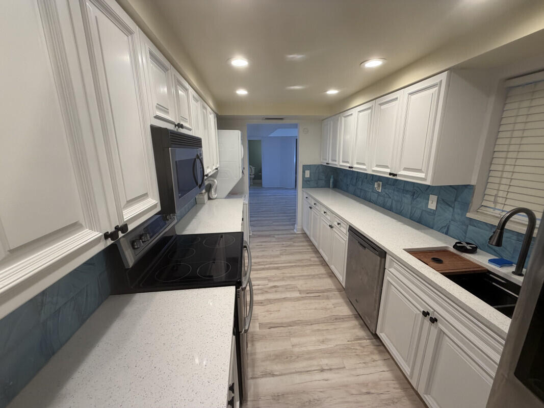 1401 South Federal Highway, Unit 102 Boca Raton, FL 33432 - Photo 3 of 38 a kitchen with granite countertop a sink and a stove top oven