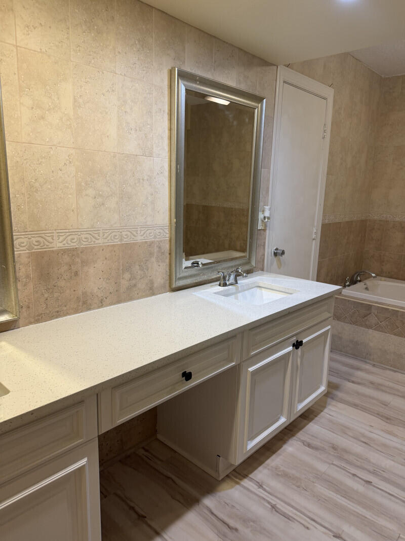 1401 South Federal Highway, Unit 102 Boca Raton, FL 33432 - Photo 32 of 38 a bathroom with a double vanity sink and a mirror