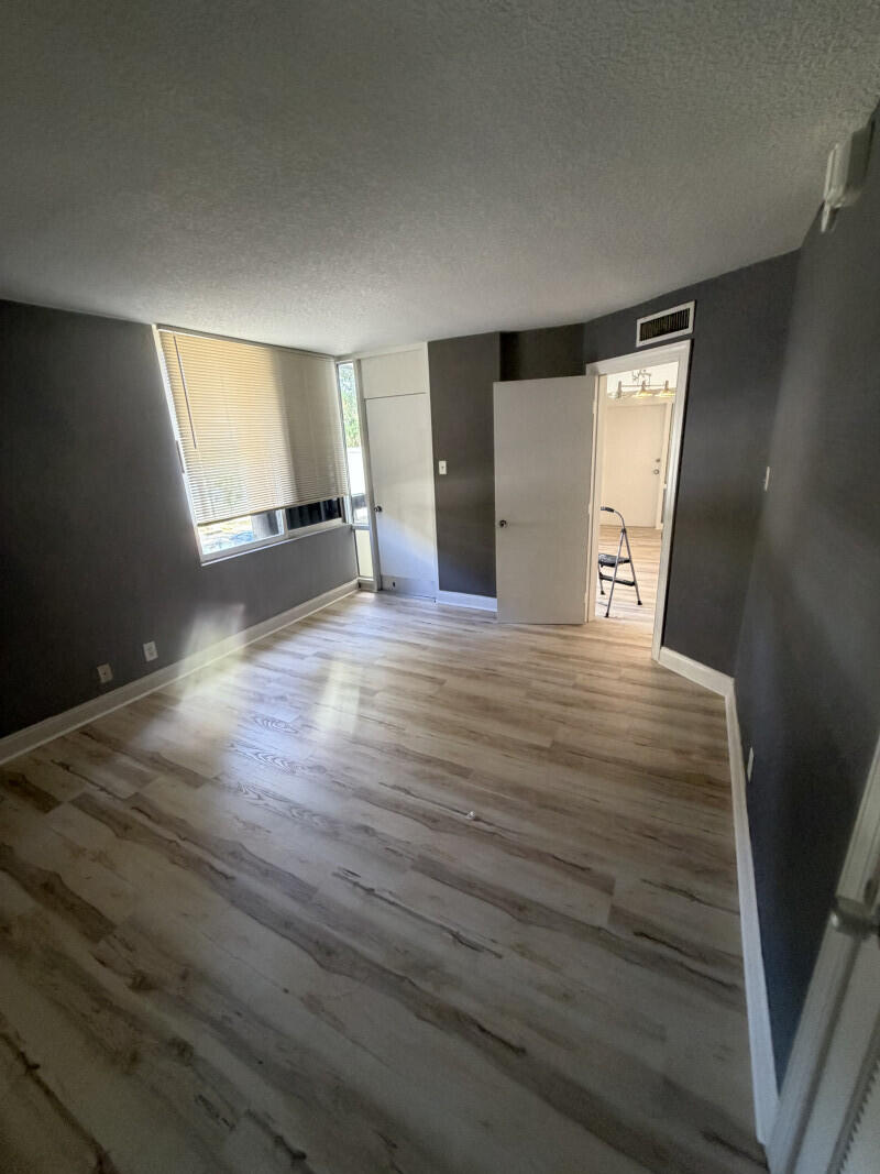 1401 South Federal Highway, Unit 102 Boca Raton, FL 33432 - Photo 34 of 38 an empty room with wooden floor and windows