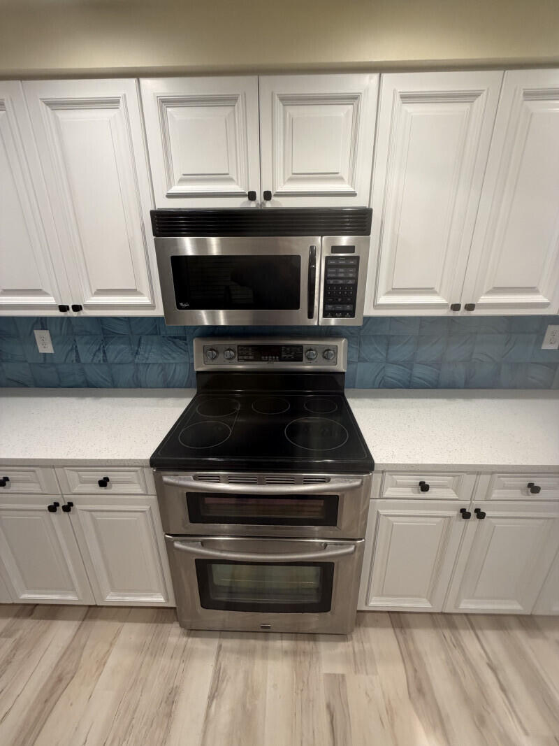 1401 South Federal Highway, Unit 102 Boca Raton, FL 33432 - Photo 5 of 38 a kitchen with granite countertop a stove and a microwave
