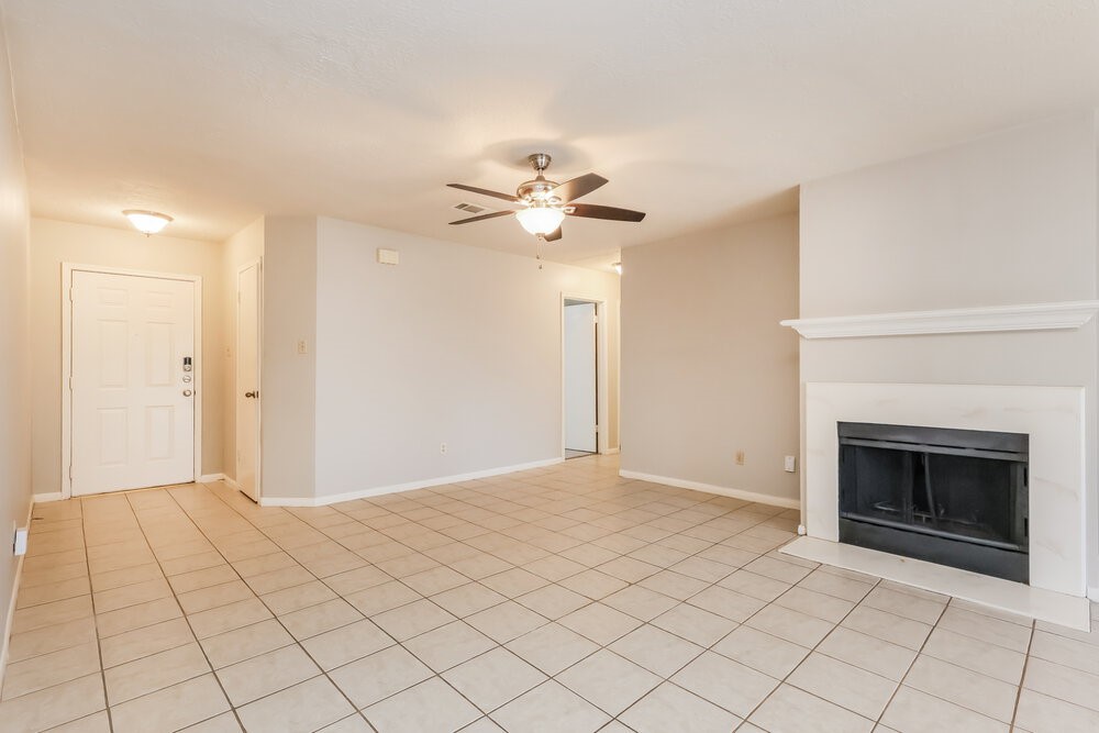 28907 Binefield Street Spring, TX 77386 - Photo 4 of 16 a view of an empty room with fan and a fireplace