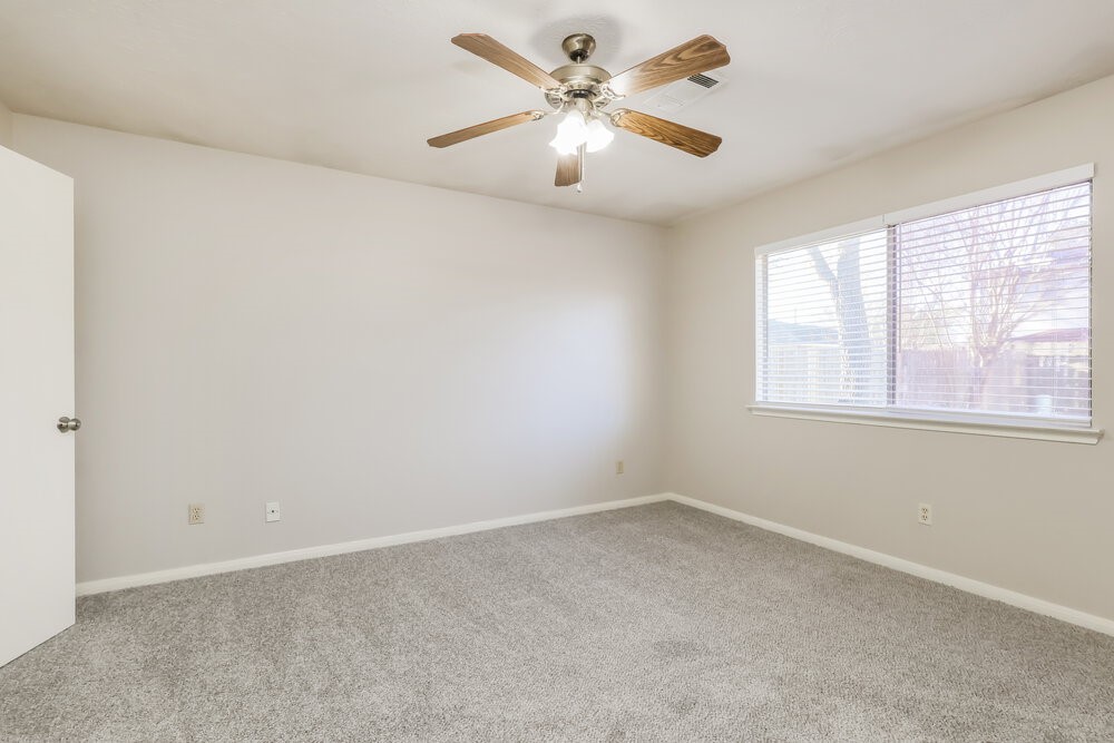 28907 Binefield Street Spring, TX 77386 - Photo 10 of 16 an empty room with a window and a fan