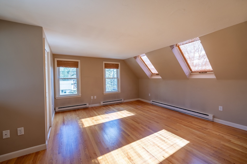 956 Bay Road, Unit 3 Hamilton, MA 01982 - Photo 21 of 30 an empty room with wooden floor and windows