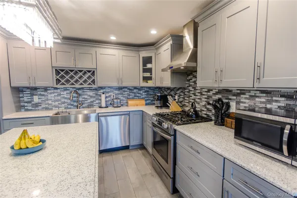 a kitchen with a stove a sink and a cabinets