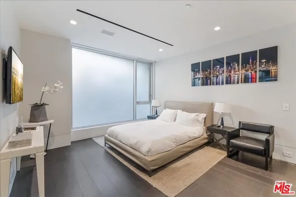 a living room with couch and a floor to ceiling window