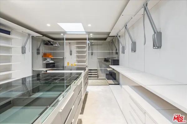 a bedroom with a large bed and a painting on the wall