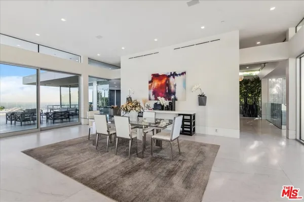 a view of a dining room with furniture wooden floor and a floor to ceiling window