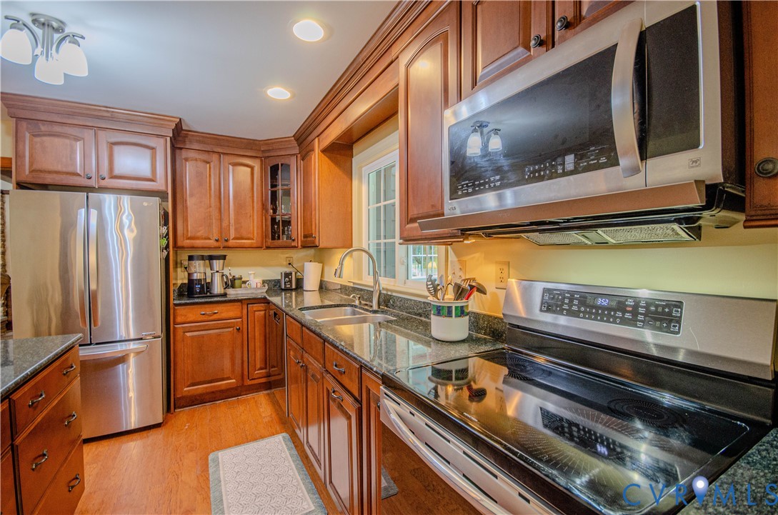 12500 Musical Lane Midlothian, VA 23113 - Photo 15 of 51 Kitchen featuring warm wood cabinetry, granite cou