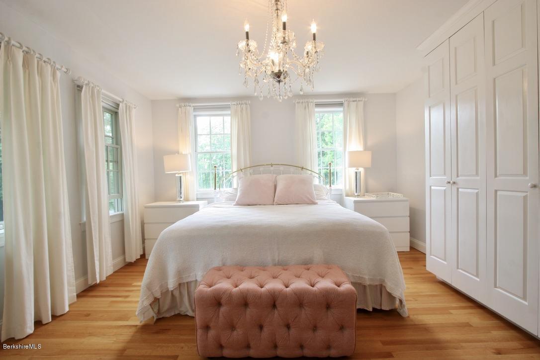 12 Prospect Hill Road Stockbridge, MA 01262 - Photo 18 of 30 a bedroom with a bed and a chandelier