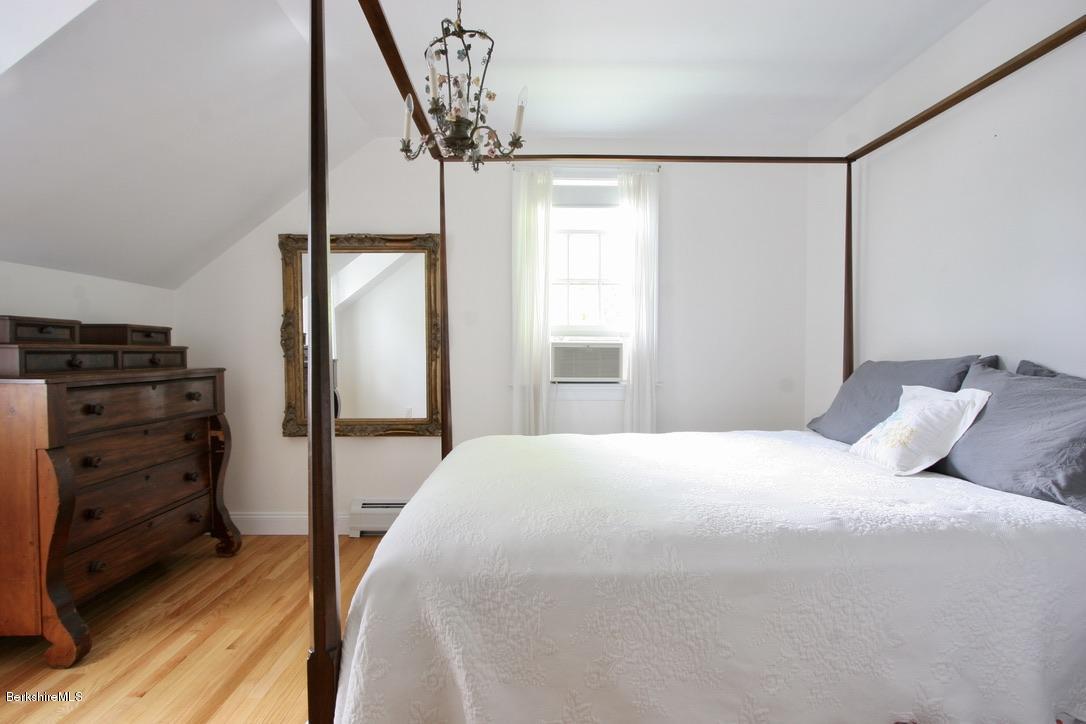 12 Prospect Hill Road Stockbridge, MA 01262 - Photo 23 of 30 a bedroom with a bed and a chandelier