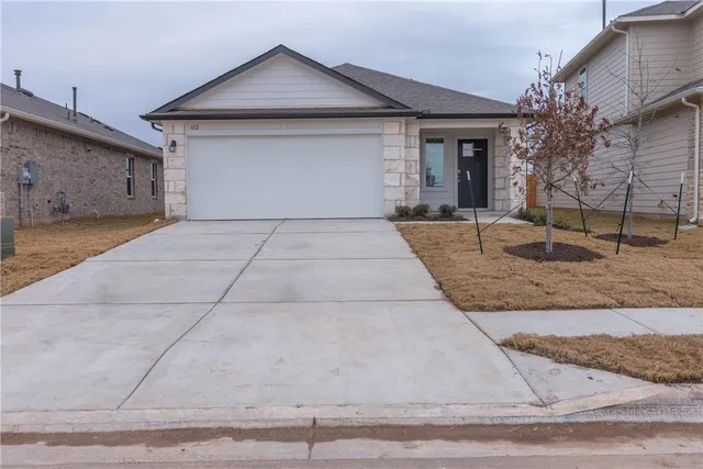 a front view of a house with garage