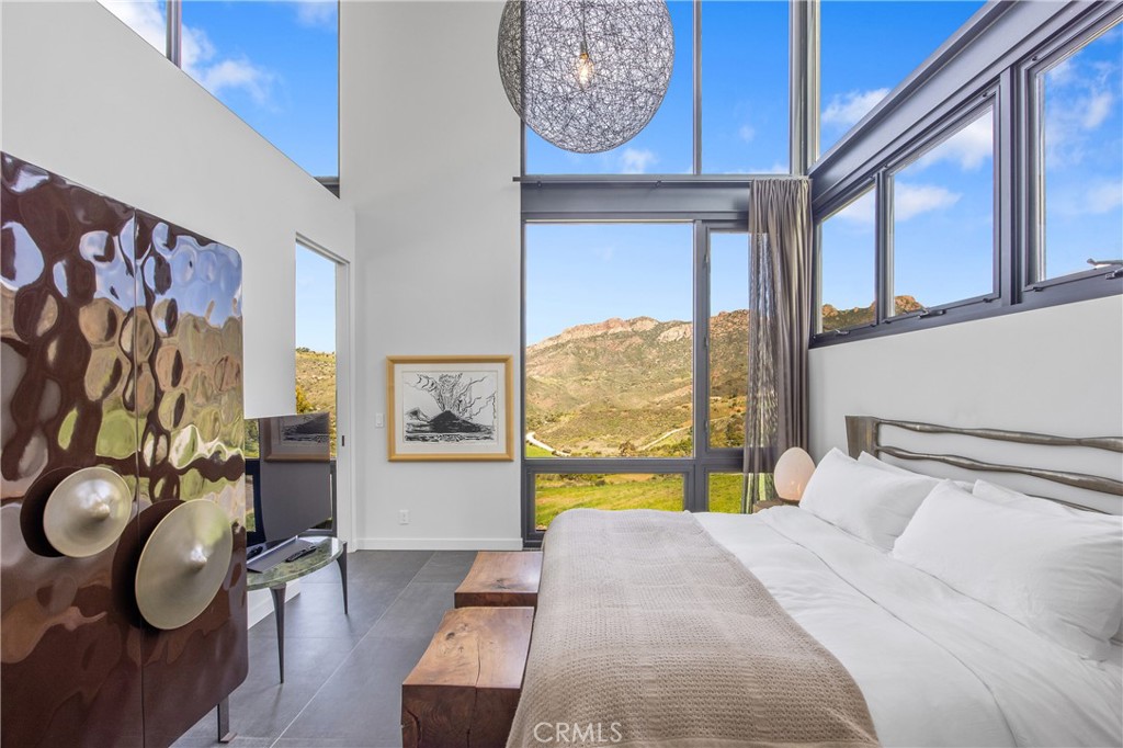 10120 Yerba Buena Road Malibu, CA 90265 - Photo 12 of 40 a bedroom with a bed and a window