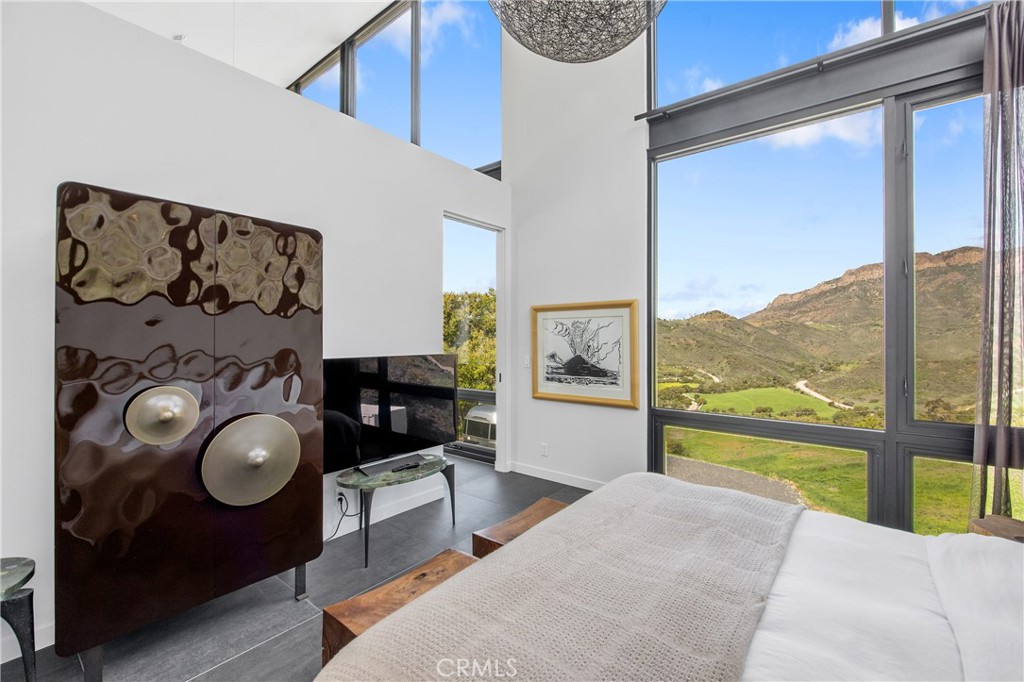 10120 Yerba Buena Road Malibu, CA 90265 - Photo 15 of 40 a bedroom with a bed and large window