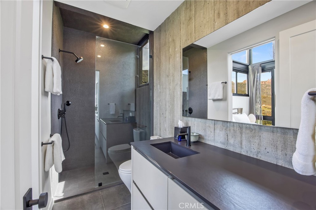 10120 Yerba Buena Road Malibu, CA 90265 - Photo 16 of 40 a bathroom with a sink a toilet and shower