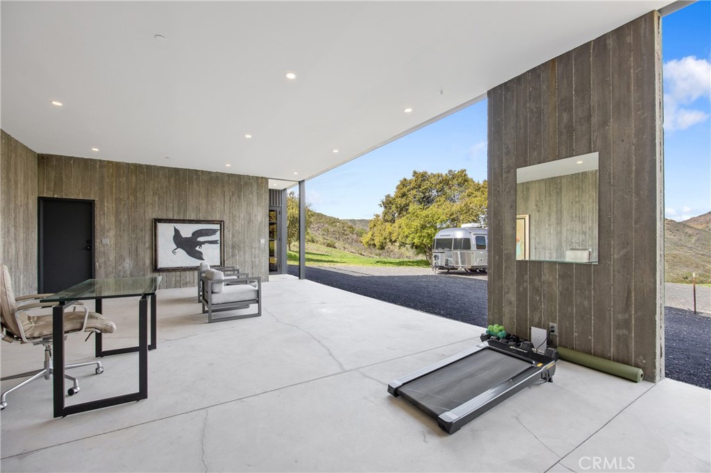 10120 Yerba Buena Road Malibu, CA 90265 - Photo 19 of 40 a living room with furniture and a flat screen tv