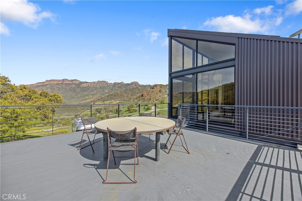 10120 Yerba Buena Road Malibu, CA 90265 - Photo 29 of 40 a view of a chairs and table in the balcony