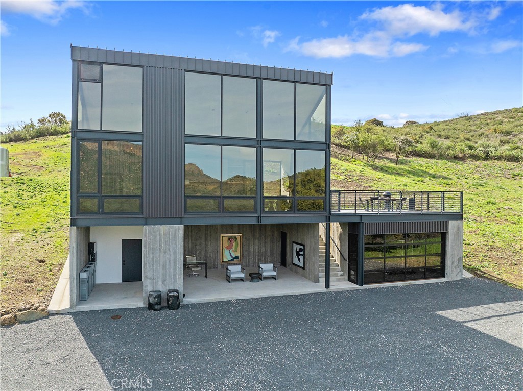 10120 Yerba Buena Road Malibu, CA 90265 - Photo 3 of 40 a front view of a house with a yard