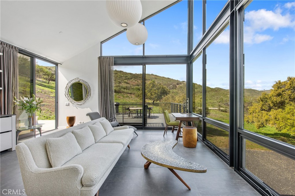 10120 Yerba Buena Road Malibu, CA 90265 - Photo 8 of 40 a living room with furniture and a floor to ceiling window