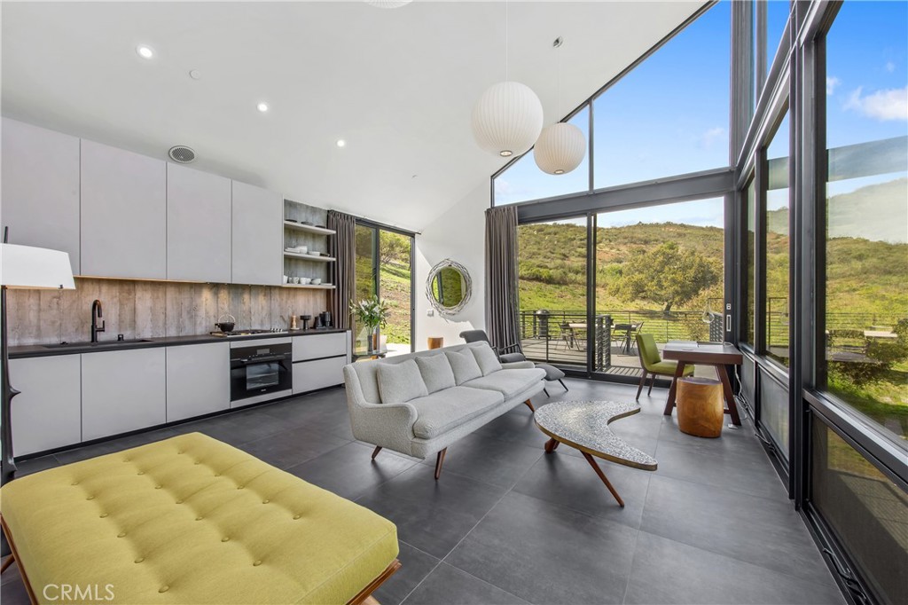 10120 Yerba Buena Road Malibu, CA 90265 - Photo 9 of 40 a living room with stainless steel appliances kitchen island furniture and a large window