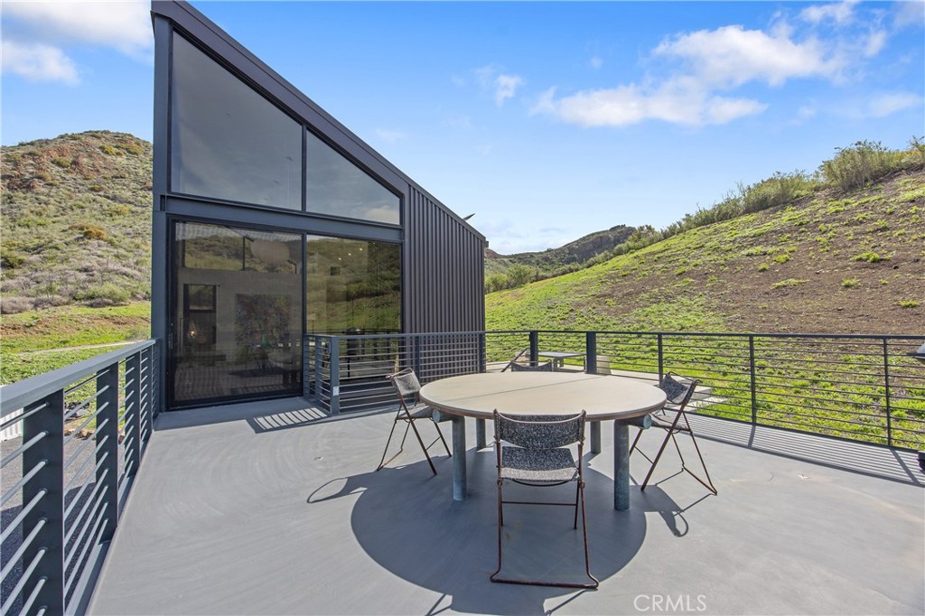 10120 Yerba Buena Road Malibu, CA 90265 - Photo 10 of 40 a balcony with table and chairs