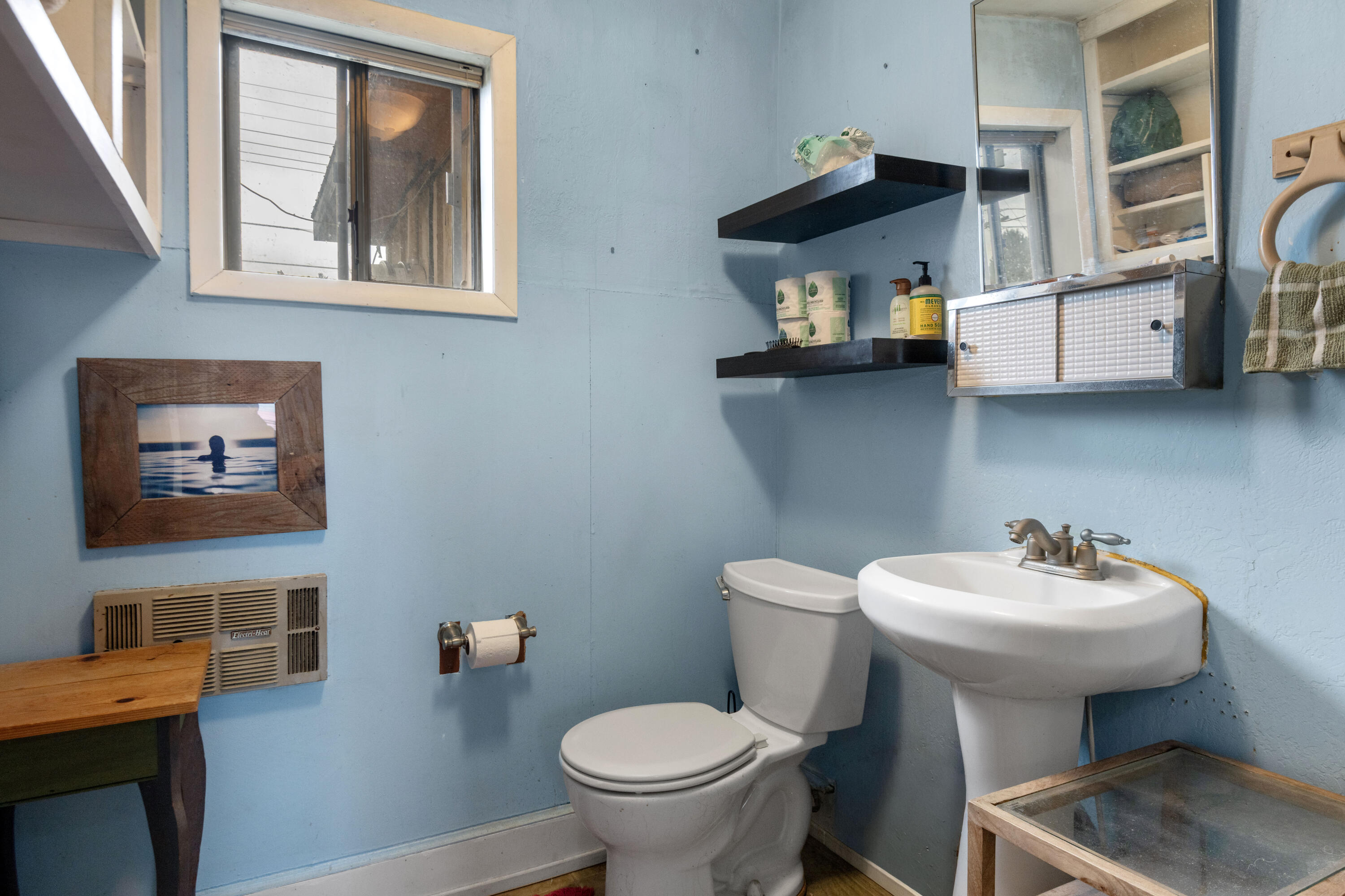 243 West Adams Avenue Sisters, OR 97759 - Photo 8 of 19 a bathroom with a sink a toilet and a mirror