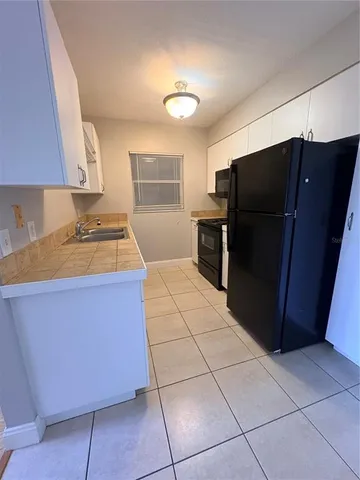 a view of a room with a kitchen