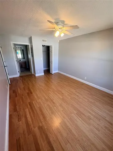 a spacious bathroom with a double vanity sink a toilet and a mirror