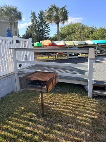a view of a roof deck with chair and wooden floor