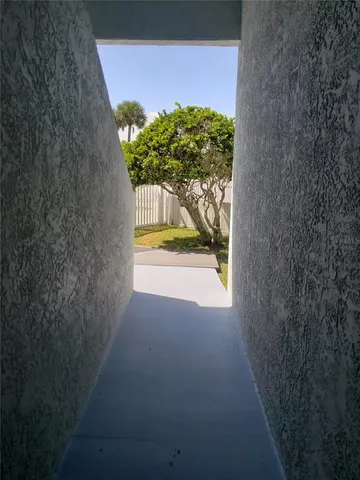 a front view of a house with a garden and yard